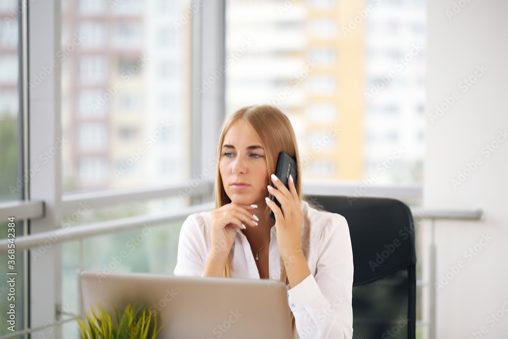 Focused woman working at her computer. Background for office startup Focused woman working at her computer. Background for office startup
