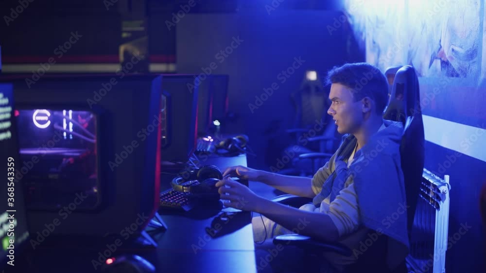 Upset and disappointed Man Playing and losing in Online Video Game in modern esport cybersport club Upset and disappointed Man Playing and losing in Online Video Game in modern esport cybersport club