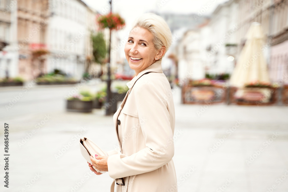 Adult stylish woman looking at camera.