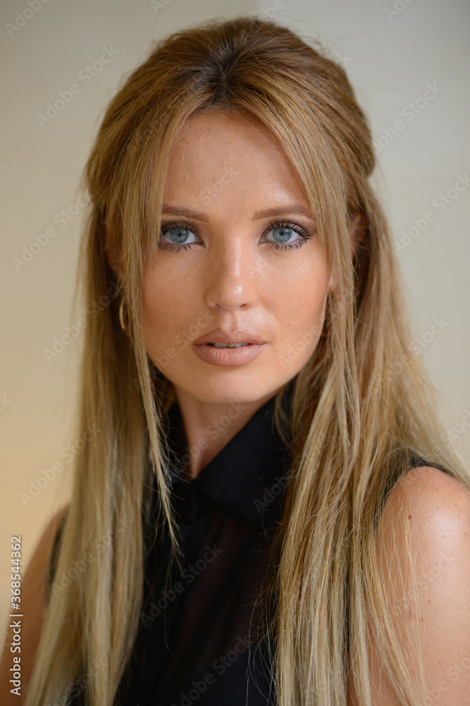 Fototapeta premium Young beautiful businesswoman with blond hair indoors