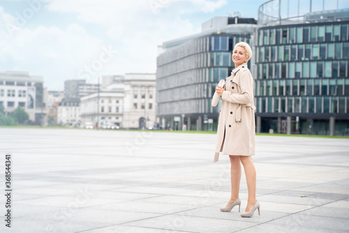 Elegant businesswoman posing outdoor.