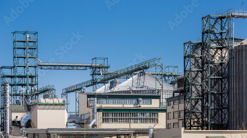 agricultural plant building with pipes and iron tanks for drying grain, granary building for agronomy business, nobody. © Александр Беспалый