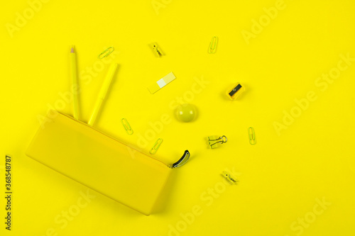 set of school stationery and pencil case in yellow monochrome concept