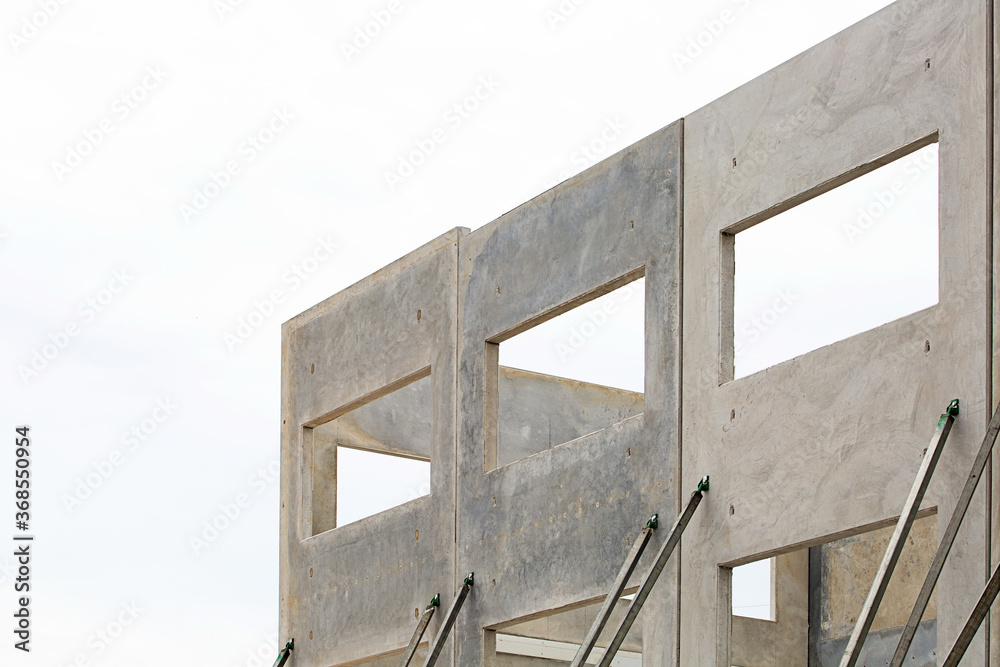 building under construction with concrete panels supported by props building under construction with concrete panels supported by props