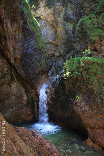 photographer at Almbachklamm taking pictures of waterfall in a narrow gorge © Chris Peters