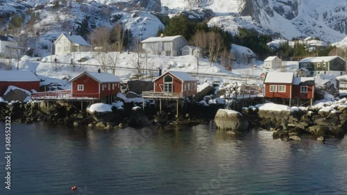 famous multicolored wooden fishing houses rorbu on a sea shore