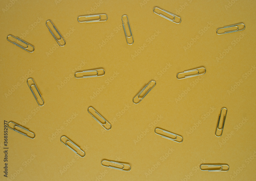 paper clips on yellow background paper clips on yellow background