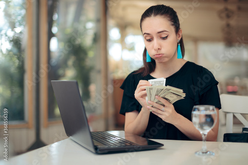 Funny Sad Woman Holding Cash Looking to Invest Online