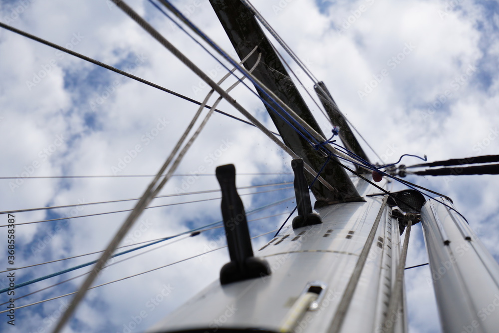Fototapeta premium Sturdy reliable mast of sailing boat photographed from below.