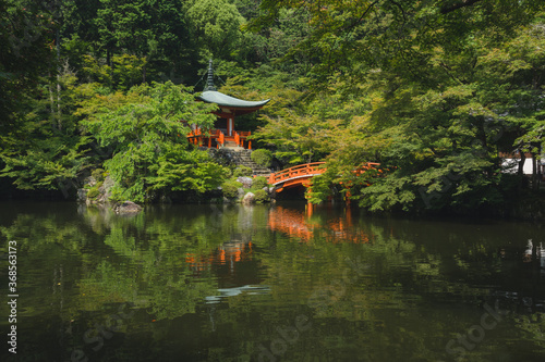Japanese garden in japan with historic Japanese temple and calm pond with a reflection