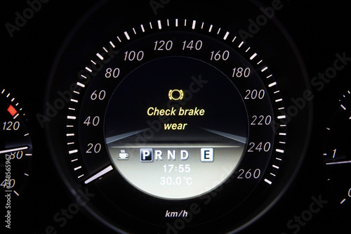 Check brake wear sign on car dashboard