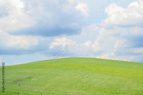 Beautiful green meadow field hill with white clouds and blue sky  background concept