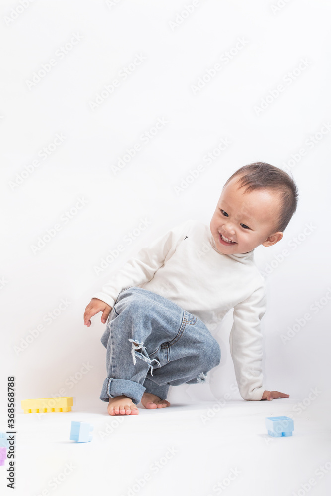 A cute two-year-old boy playing with a toy A cute two-year-old boy playing with a toy