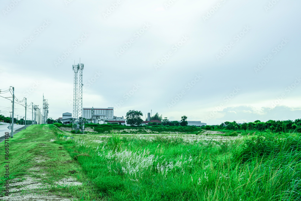 Green fields with modern factory buidling for green industry concept Green fields with modern factory buidling for green industry concept