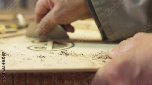 Craftsman artisan file wood with sharp knife to make guitar slow motion