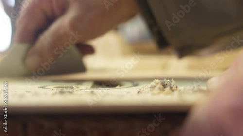 Craftsman artisan file wood with sharp knife to make guitar slow motion