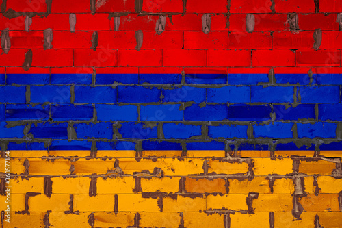 The national flag of Armenia painted on a wall of sibit blocks with cement . The symbol of the country.