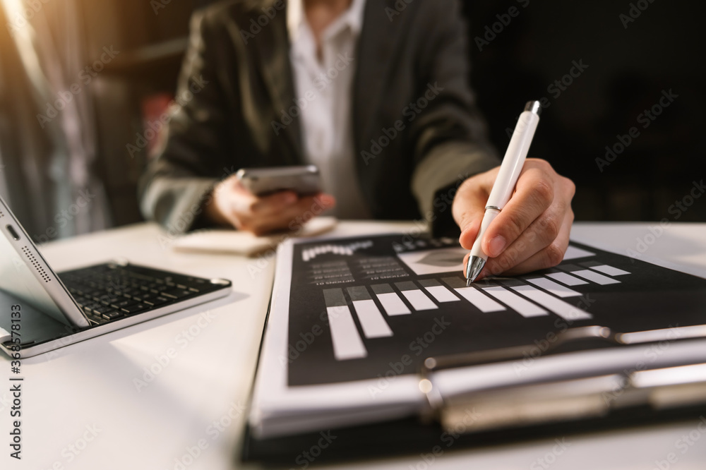 Business counting coins on calculator taking from the piggy bank. hand holding pen working on calculator Business counting coins on calculator taking from the piggy bank. hand holding pen working on calculator