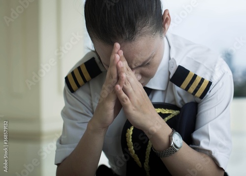 Stressed pilot looking down worried in the airport. Aviation.