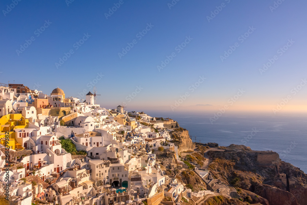 White Houses and Windmills on a Mountainside in Oia Town