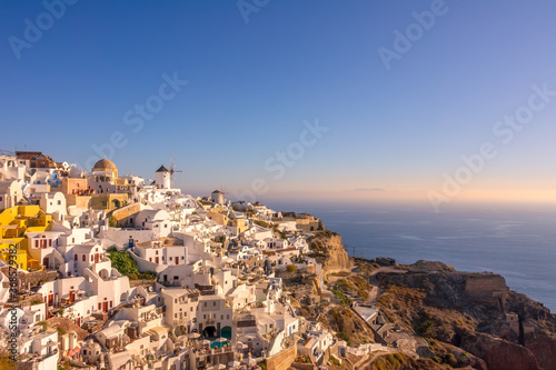 White Houses and Windmills on a Mountainside in Oia Town © goodman_ekim