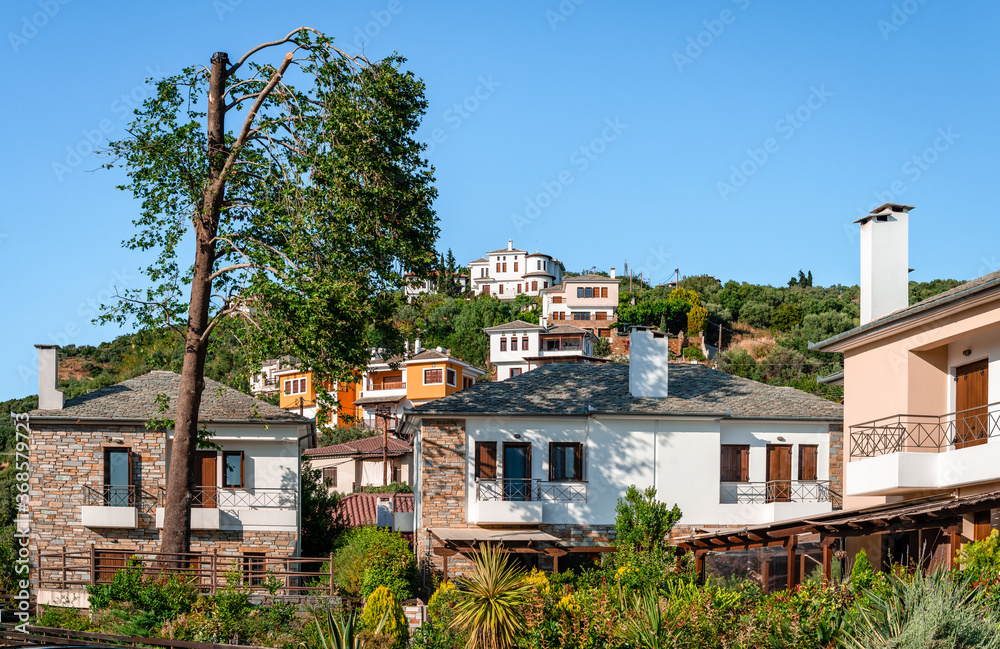 Mansions in Afissos, a historic village on the slopes of Mount Pelion, Greece. The mansions are built of stone and wood and the roofs are covered with the famous characteristic grey slates