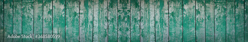 Old painted wood planks background. Long banner with green shabby planks texture. Vintage wood background.