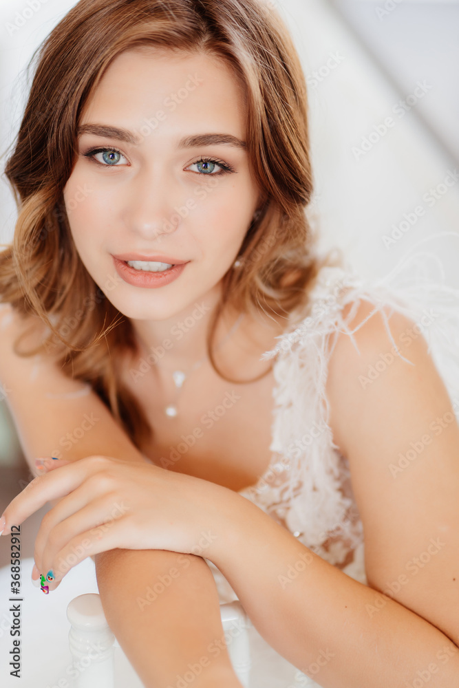 Naklejka premium portrait bride in wedding dress with feathers.