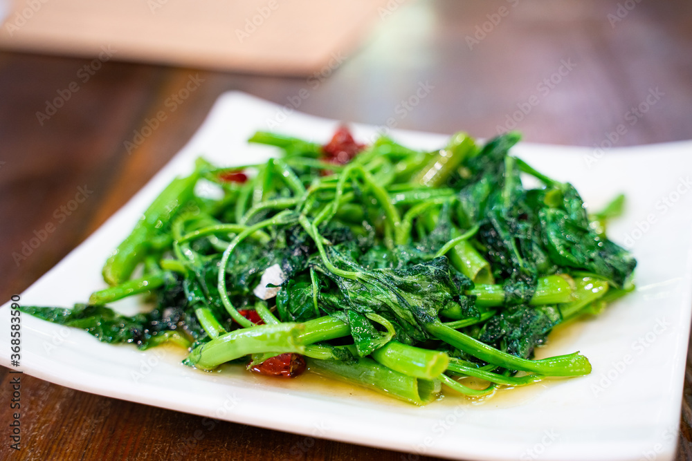 Fried beam seedings with garlic and red pepper, a traditional Sichuan cuisine in China. Fried beam seedings with garlic and red pepper, a traditional Sichuan cuisine in China.