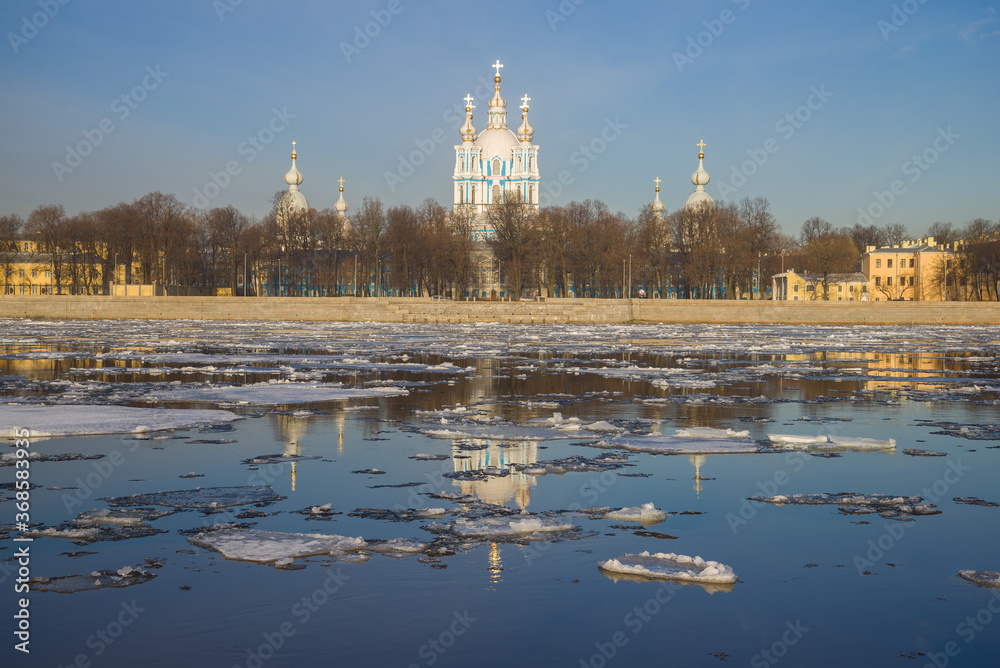 Spring ice drift on the background of Smolny Cathedral on a sunny April day. Saint-Petersburg, Russia