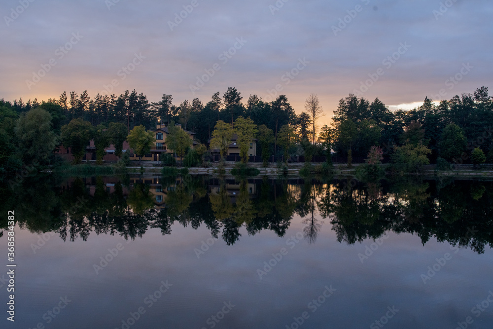 sunset on the lake in the forest