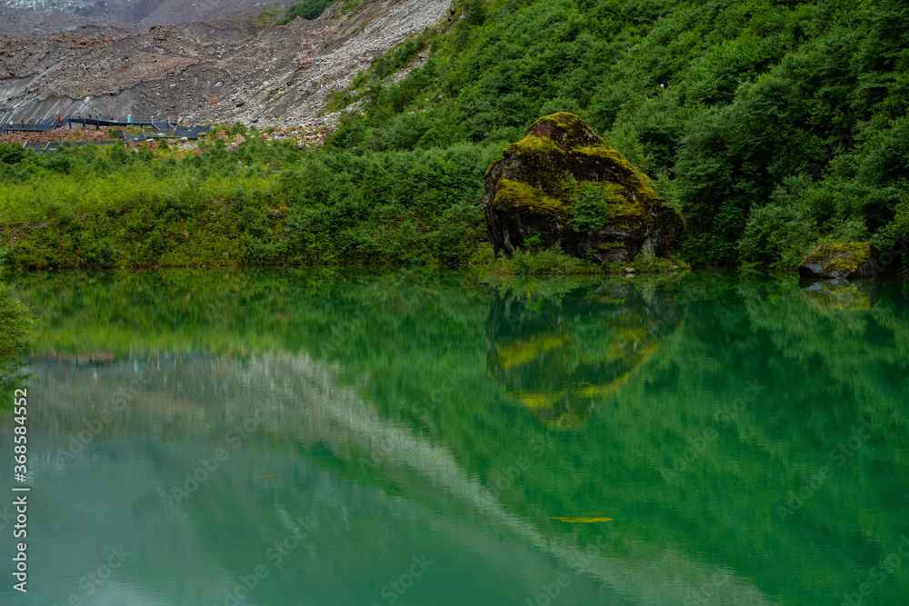 Fototapeta premium The Jade lake in Conch Gully of Sichuan, China, with reflection.