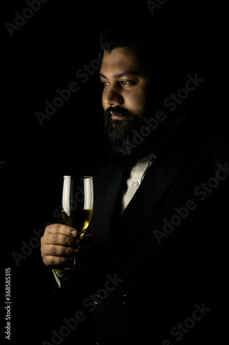 Business man with long beard and campaign glass in black suit