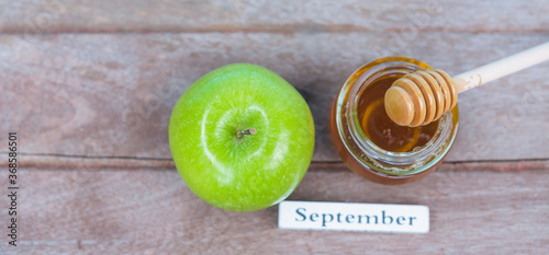 Jewish holiday, Apples Rosh Hashanah on the photo have honey in jar have green apples on wooden background photo