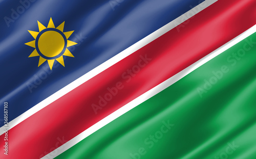 Free Download Silk wavy flag of Namibia graphic. Wavy Namibian flag 3D illustration. Rippled Namibia country flag is a symbol of freedom, patriotism and independence. - GFXLoad