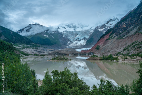 Fototapeta Naklejka Na Ścianę i Meble -  Midui Glacier, a big glacier on mountains in Tibet, China, on summer time, on a cloudy day.