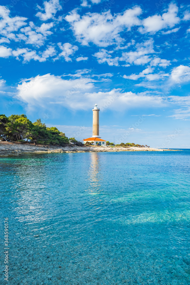 Lighthouse of Veli Rat on the island of Dugi Otok, Croatia, beautiful sea bay in foreground