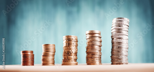 stacked coins on blue background. Money columns photo