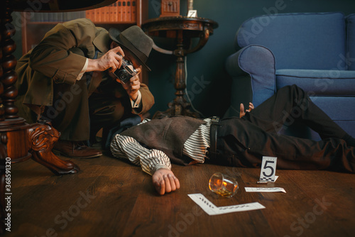 Male detective with photo camera, crime scene photo
