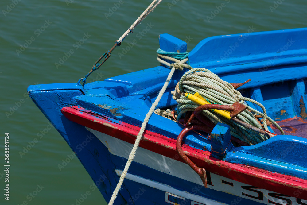 bow of a fishing boat with an anchor and ropes in Tavira, Portugal