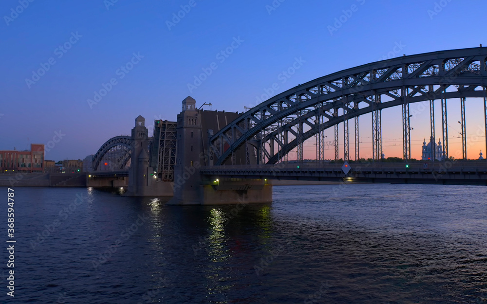 The Bolsheokhtinsky Bridge is a beautiful drawbridge across the Neva River in St. Petersburg. The Bolsheokhtinsky Bridge is a beautiful drawbridge across the Neva River in St. Petersburg.