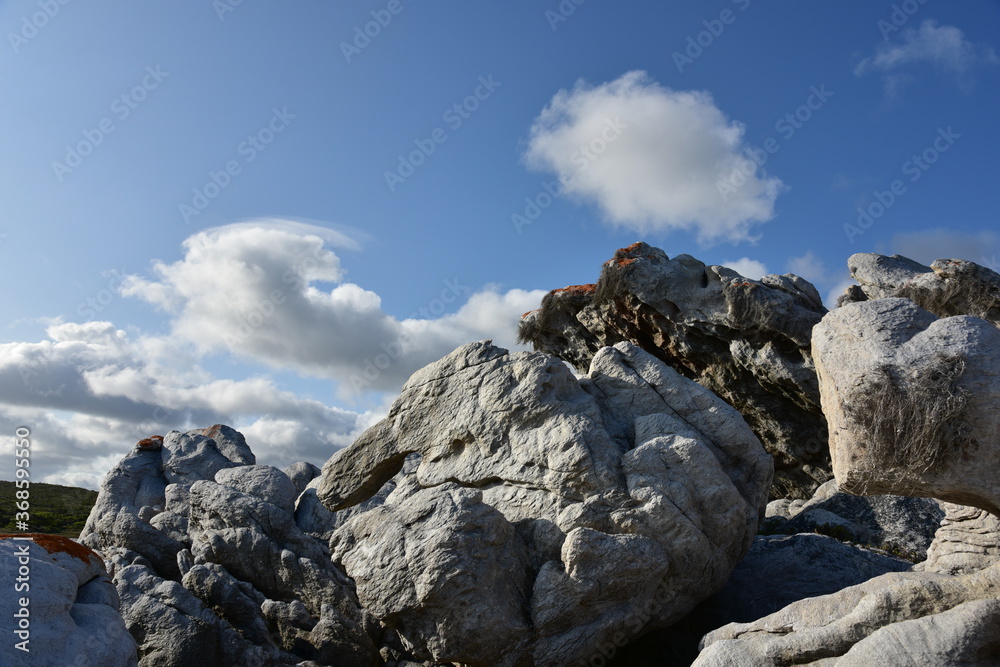 White clouds gliding over rugged rocks near L'Agulhas, where the Indian and Atlantic Oceans meet