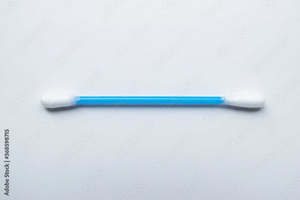 Cotton sticks ear blue plastic on a white background. Personal hygiene and care. Cosmetology and medicine. Cotton sticks ear blue plastic on a white background. Personal hygiene and care. Cosmetology and medicine.