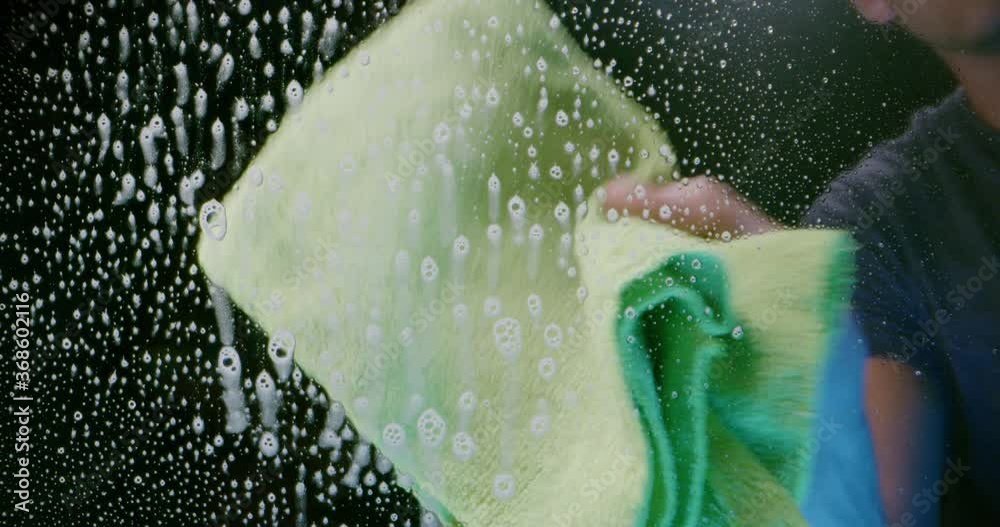 Man cleaning window with spray