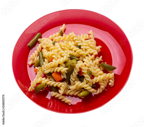 pasta with green beans with garlicand carrots on a plate isolated on a white background. Mediterranean Kitchen . photo