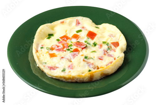 omelet with tomatoes and green onions on a plate isolated on white background.omelet top view. healthy breakfast