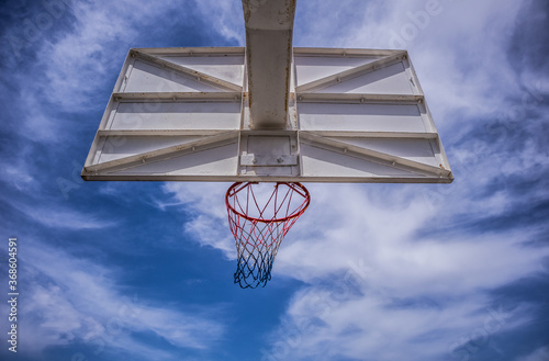 basketball ring with blue sky and clouds