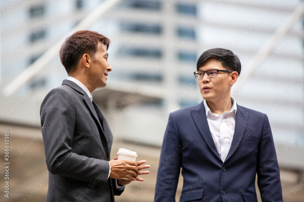 Business people walking down the stairs in the street, while talking and laughing Business people walking down the stairs in the street, while talking and laughing