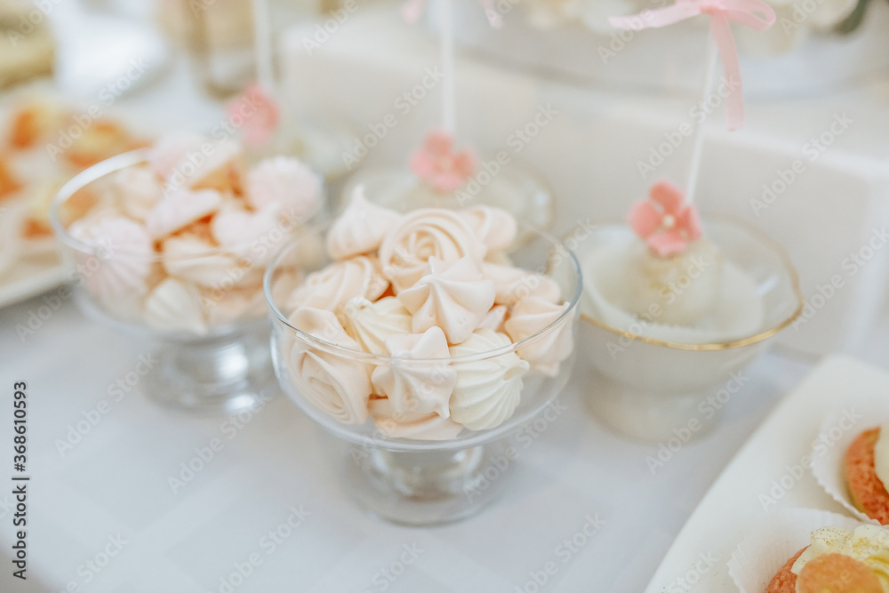 Candy bar at the banquet. Wedding table with sweets, cake, pastries, muffins, sugar treats. Event in the restaurant