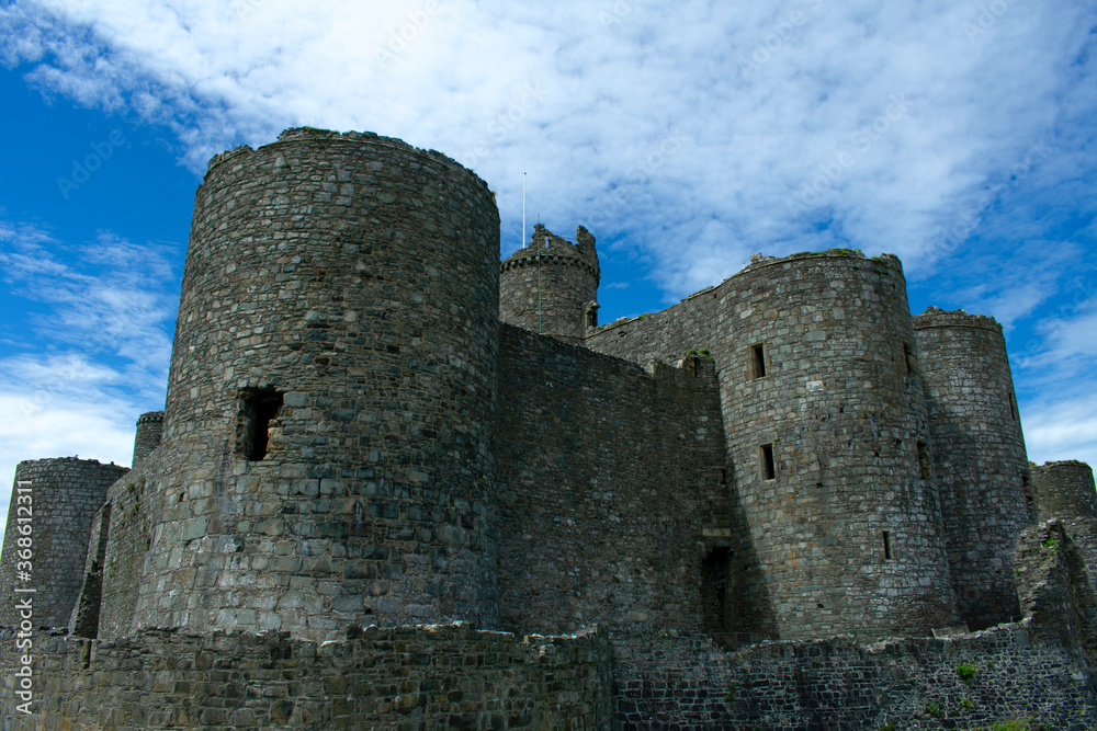Wales, the historic seaside town of Harlech.  The imposing medieval castle with dramatic towers and austere defensive walls.  Blue skies on a summers day - copy space.